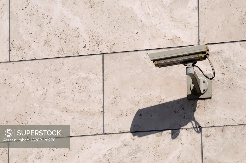 Close-up of surveillance camera mounted on stone wall, Berlin, Germany. 07/28/2013