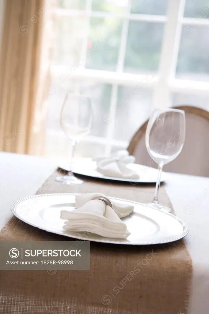 Simple and elegant place setting for two with plate charger and napkin. 08/24/2013