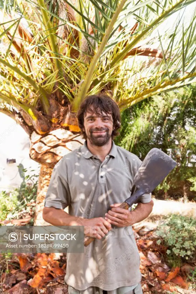 Portrait of man holding blade for peeling palm tree, Majorca, Spain. 09/16/2013