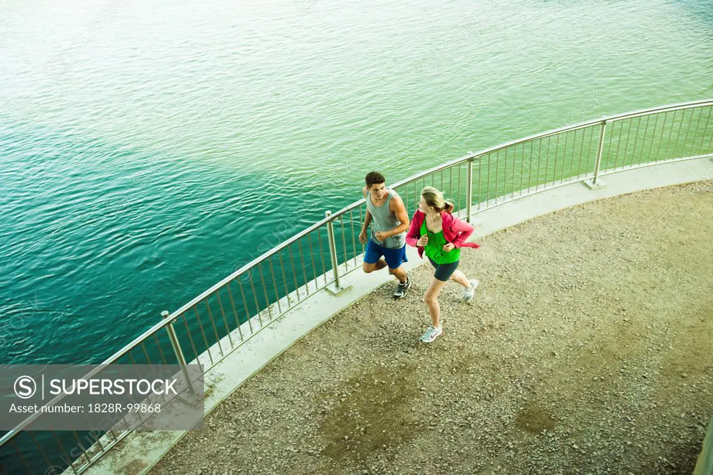 Young Couple Running by Water, Worms, Rhineland-Palatinate, Germany. 09/03/2013