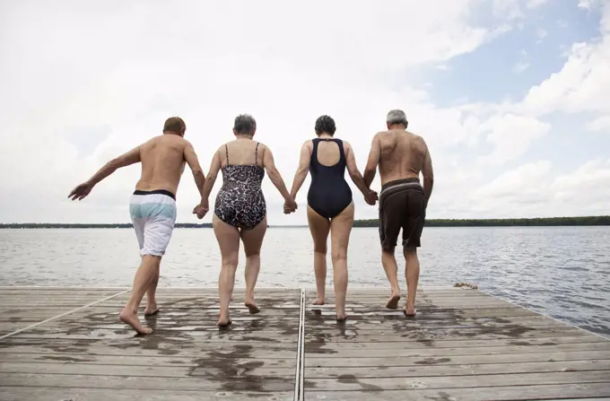 Couples Jumping off Dock   