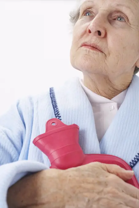 Portrait of Elderly Woman Holding Hot Water Bottle   