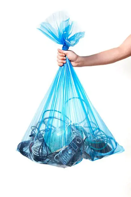 Person Holding Blue Recycling Bag Full of Electronics
