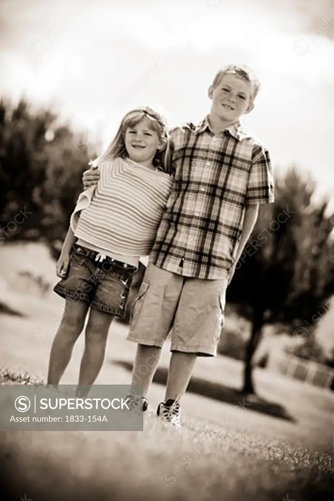 Boy and his sister standing together, California, USA