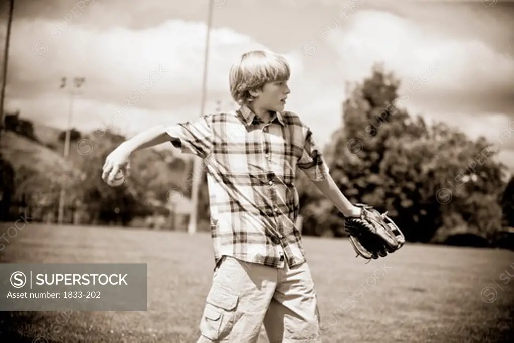 Boy playing baseball in a field
