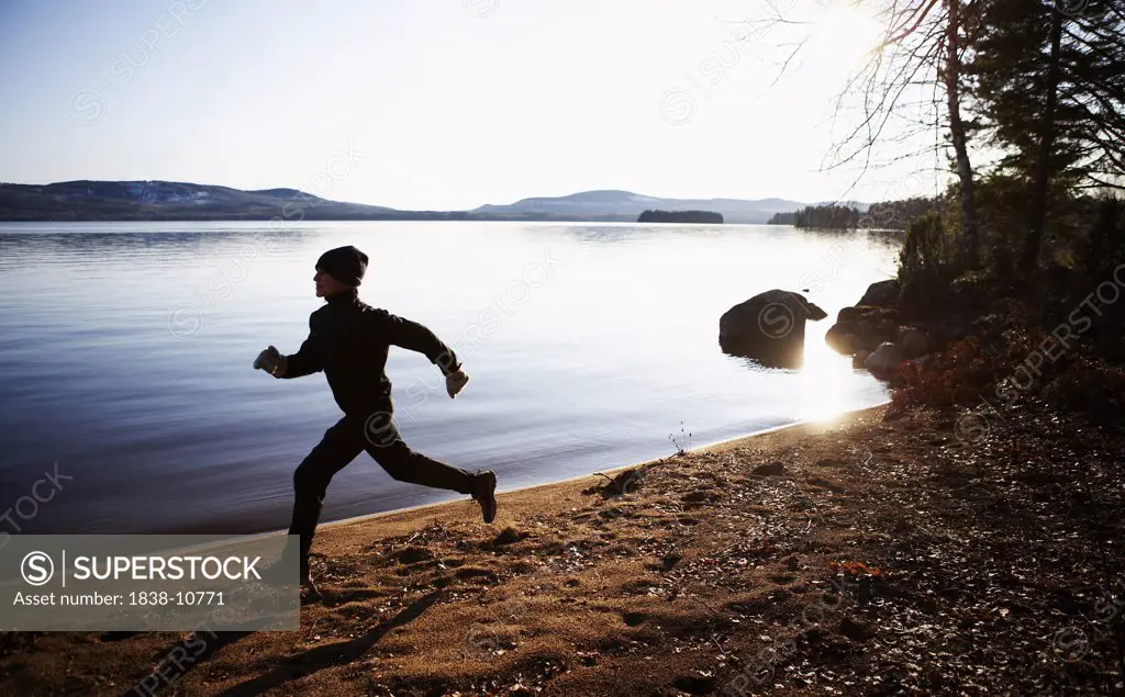 Woman Running Along Lake, Halsingland, Sweden