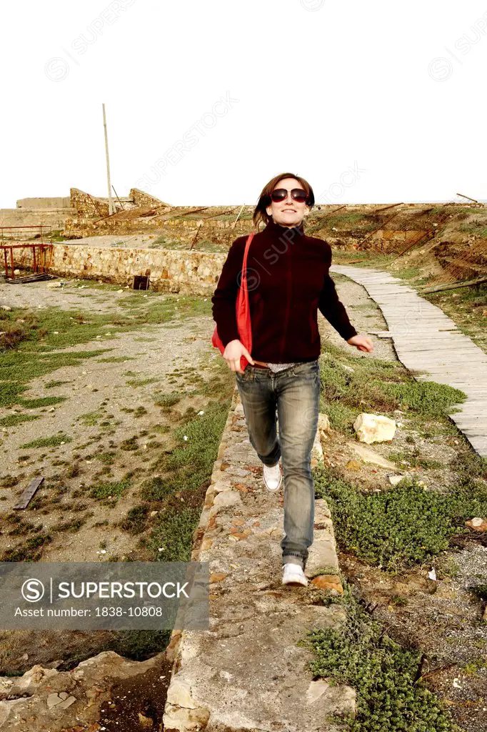 Woman Running on Stone Wall, La Linea de la Concepcion, Spain