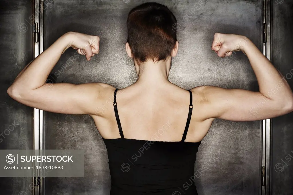 Woman Flexing Arm Muscles, Rear View