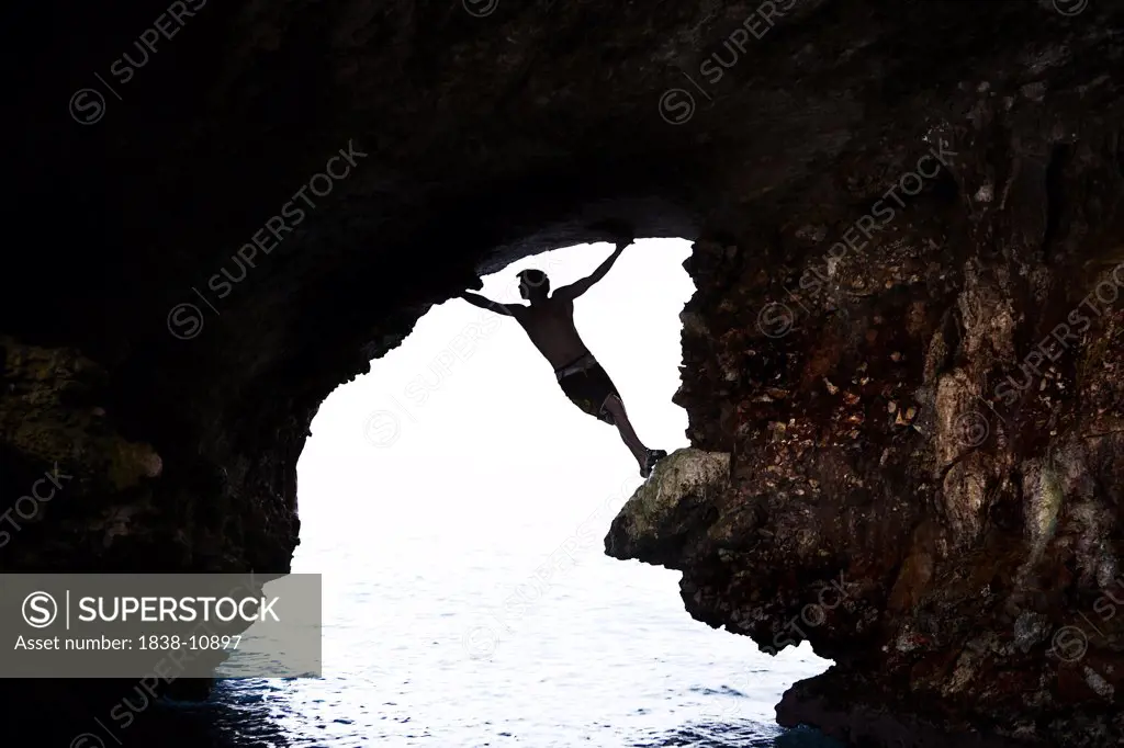 Male Rock Climber in Sea Cave, Mallorca, Spain