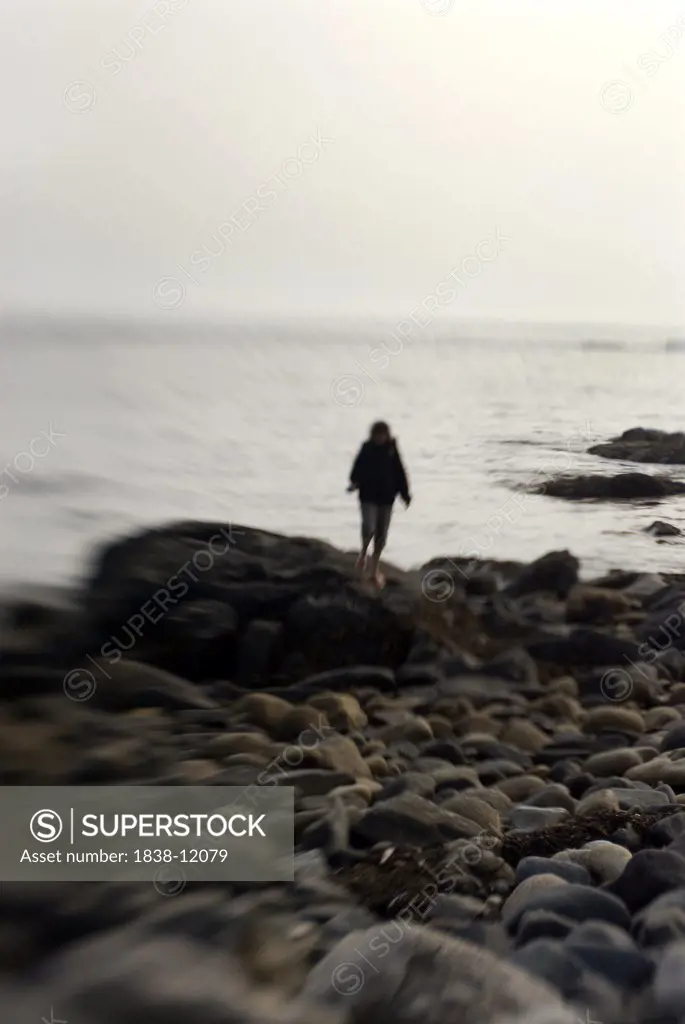 Young Woman on Rocky Shore