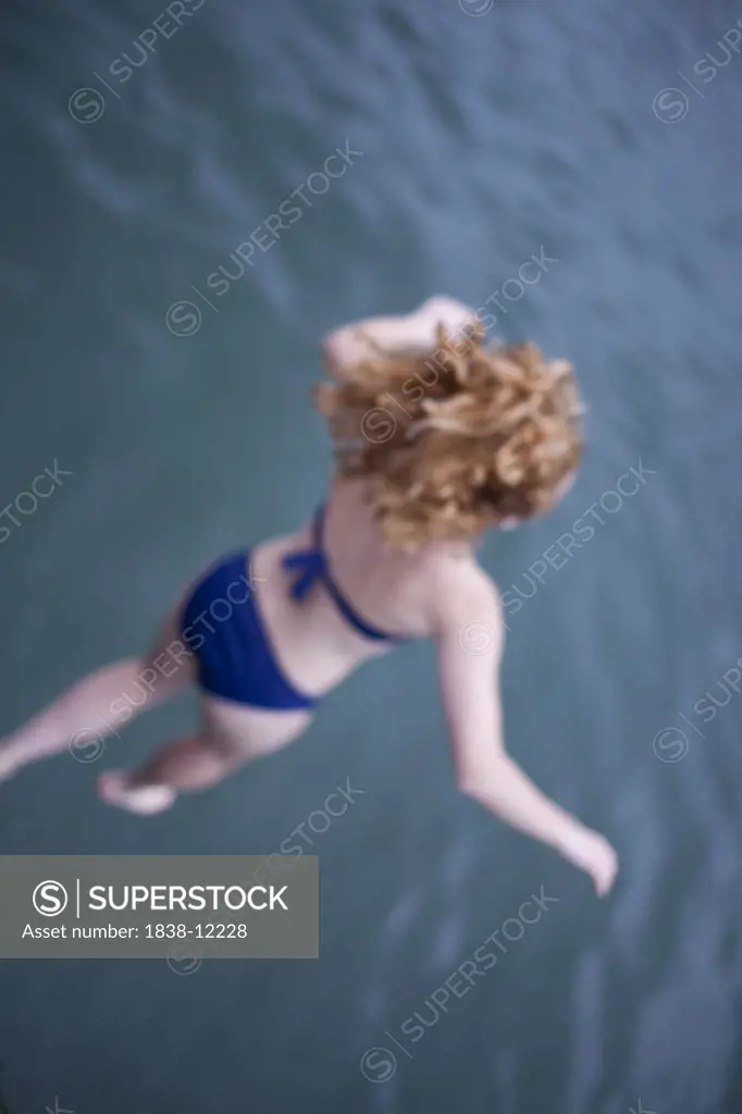 Woman Jumping into Water