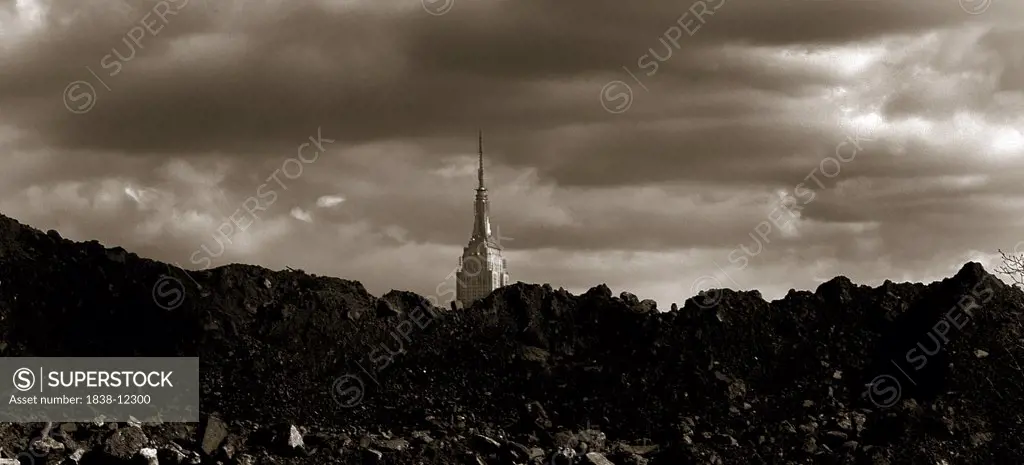 Empire State Building Behind Mounds of Rubble Under Cloudy Sky, New York City, USA