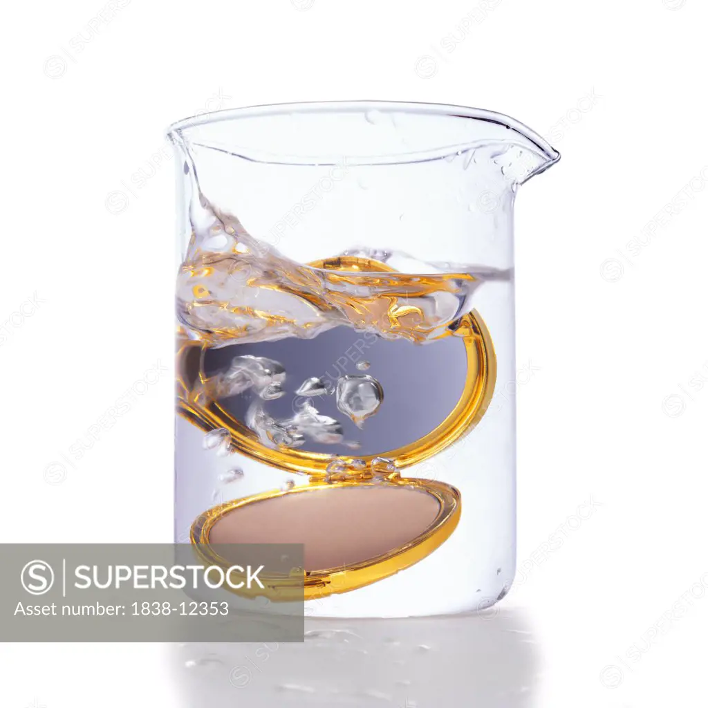 Gold Compact in Beaker of Water