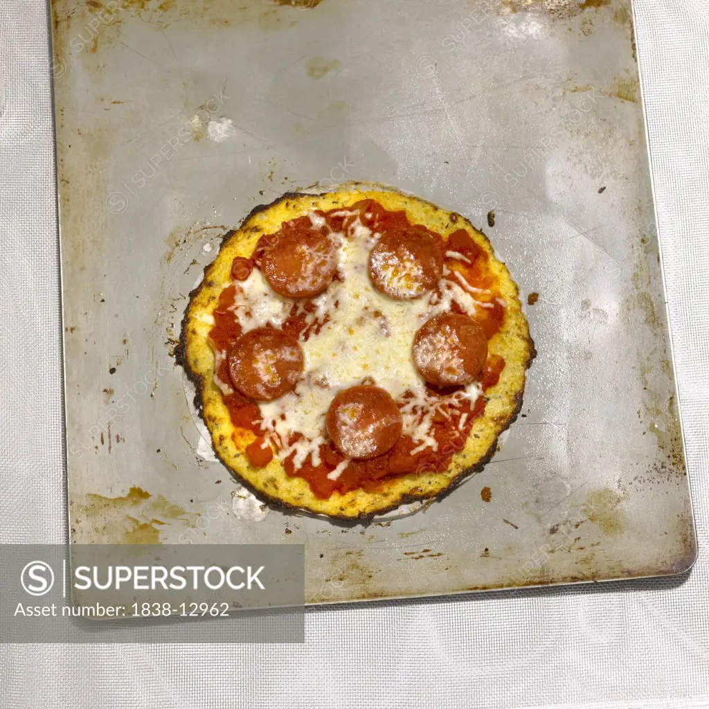 Small Cauliflower Crust Pepperoni Pizza on Baking Sheet