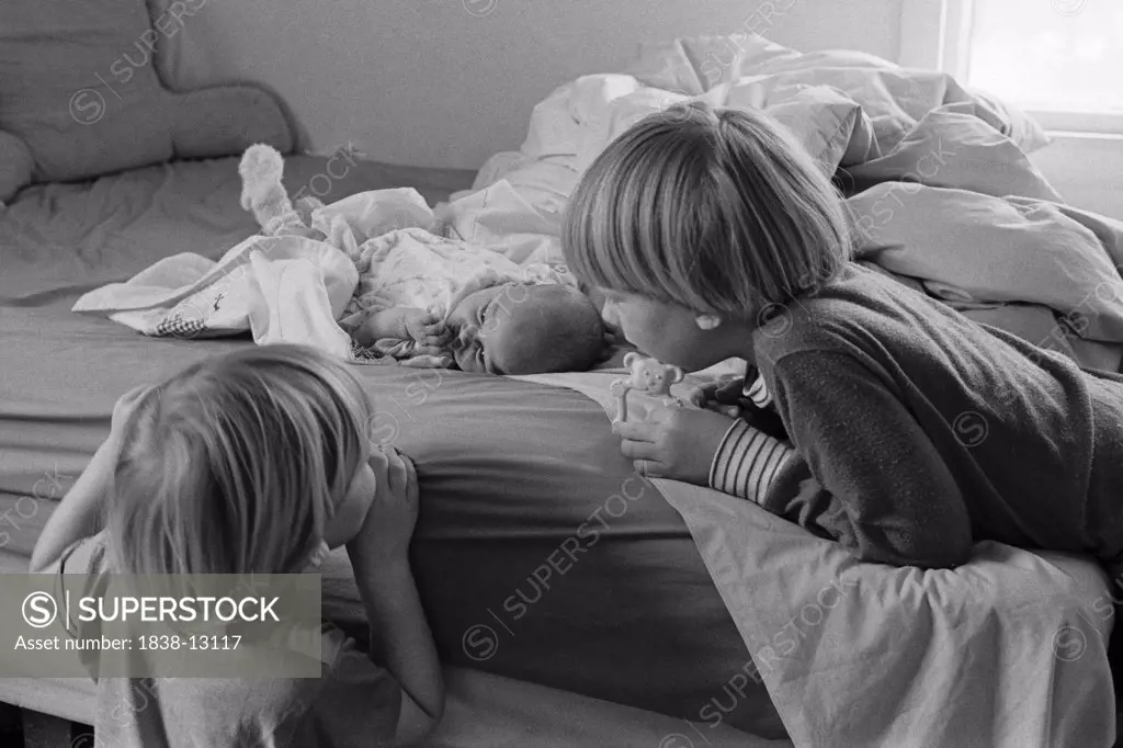Young Boys Looking at Newborn Baby,