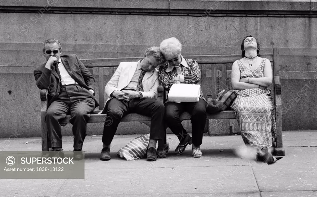 Four People Resting on Street Bench