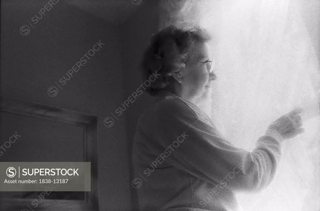Elderly Woman Looking Out Window