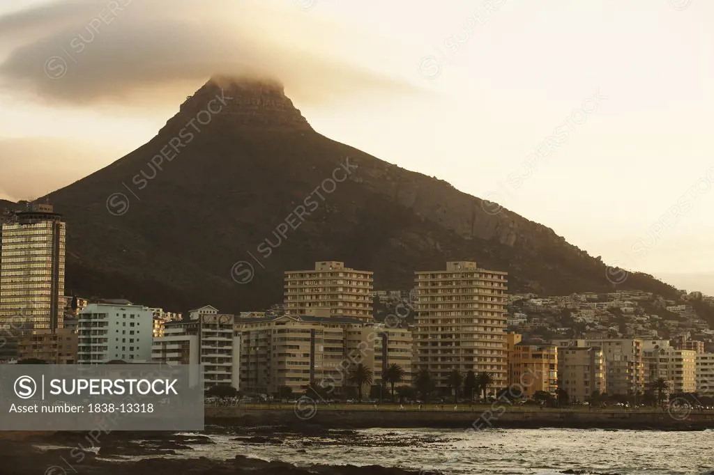 Apartment Buildings Along Beachfront With Volcano in Background, Cape Town, South Africa