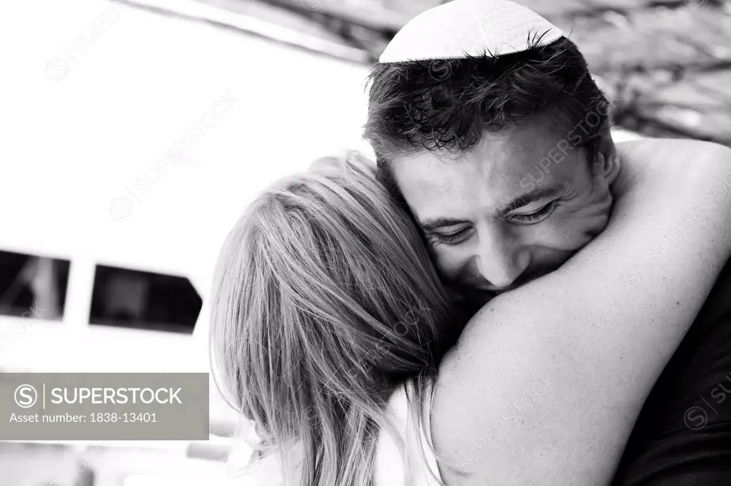 Woman Hugging Man Wearing Yarmulke