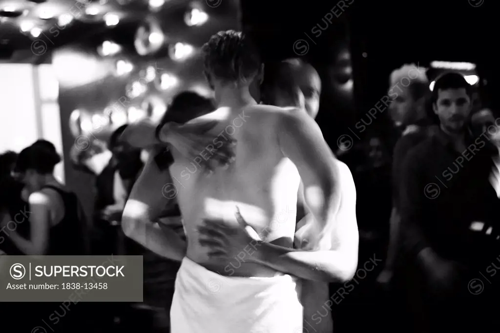 Two Men in Towels Embracing in Nightclub, New York City, USA