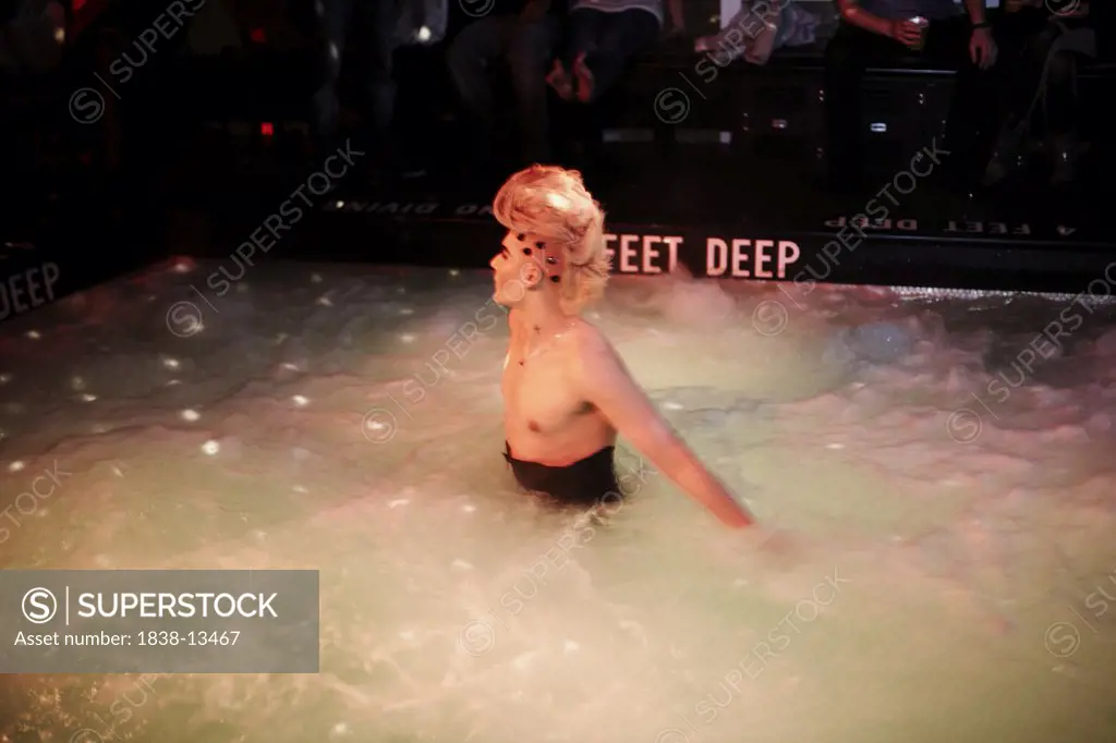 Young Man in Costume in Jacuzzi at Nightclub, New York City, USA
