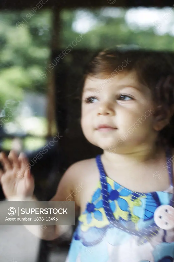 Baby Girl Leaning Against Window