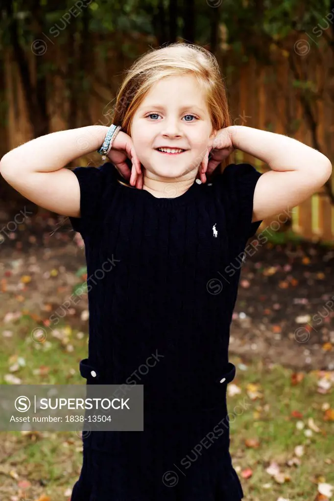 Young Smiling Girl With Hands on Shoulders