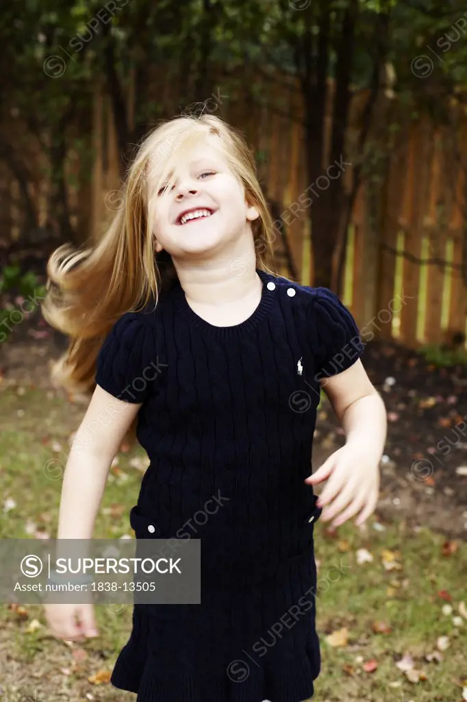 Young Smiling Girl in Navy Blue Dress