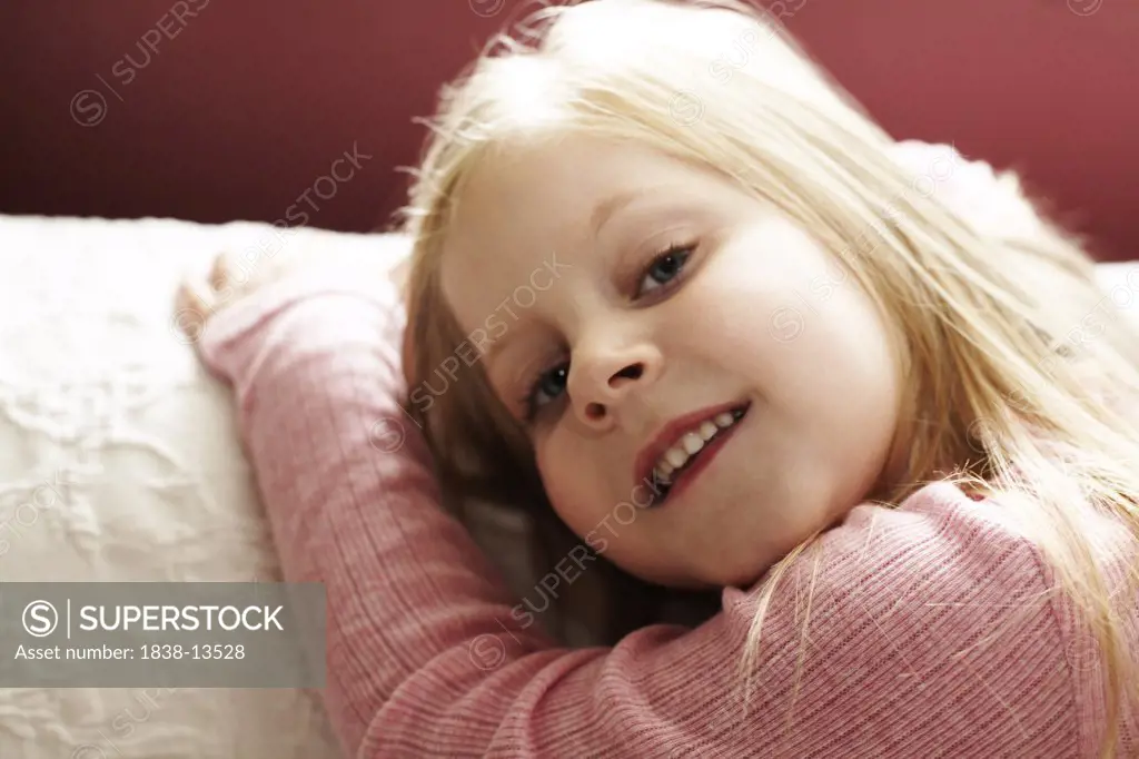 Smiling Blond Girl in Pink Shirt