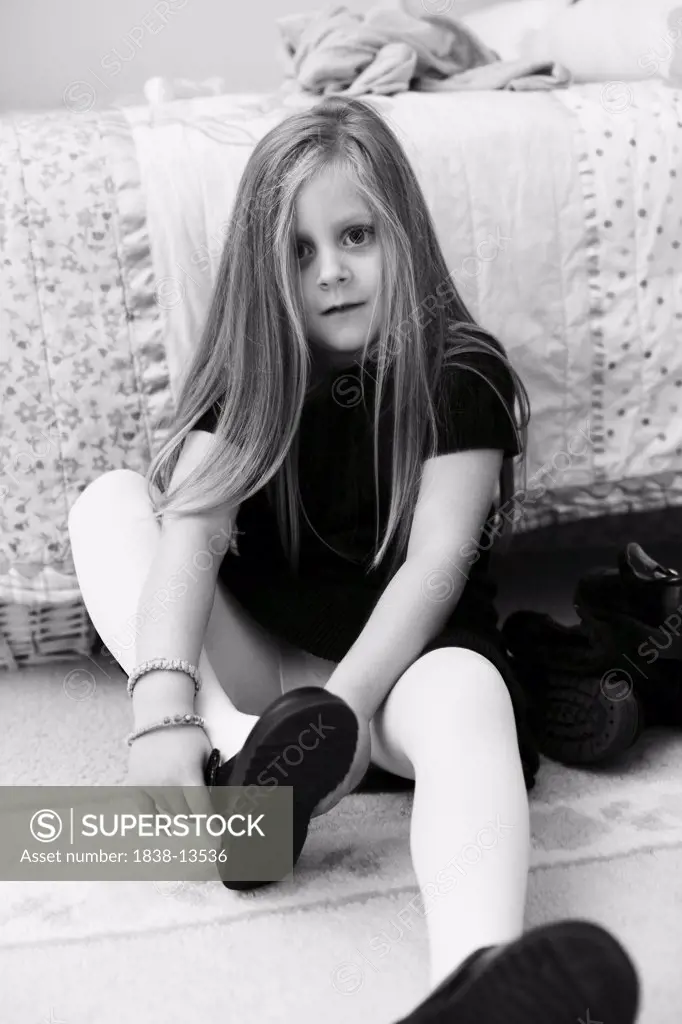 Young Girl Putting on Shoes