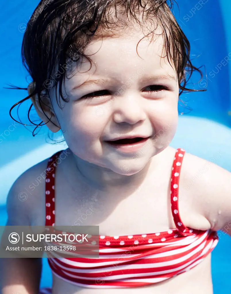 Young Girl in Red Bathing Suit Sitting in Small Pool, Close Up,