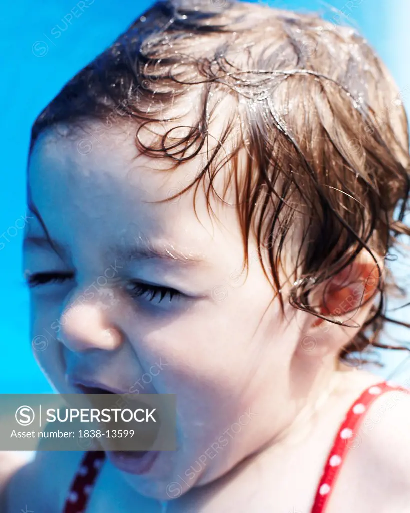 Young Girl in Red Bathing Suit Sitting in Small Pool, Close Up