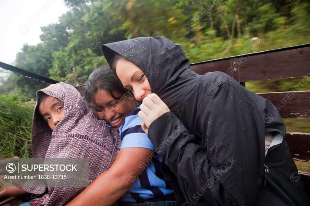 Women and Child Riding on Truck in Rain, Guatemala