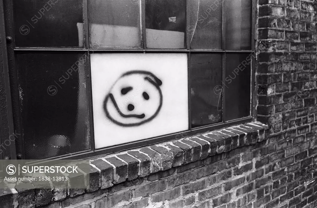 Smiley Face Painted on Urban Window