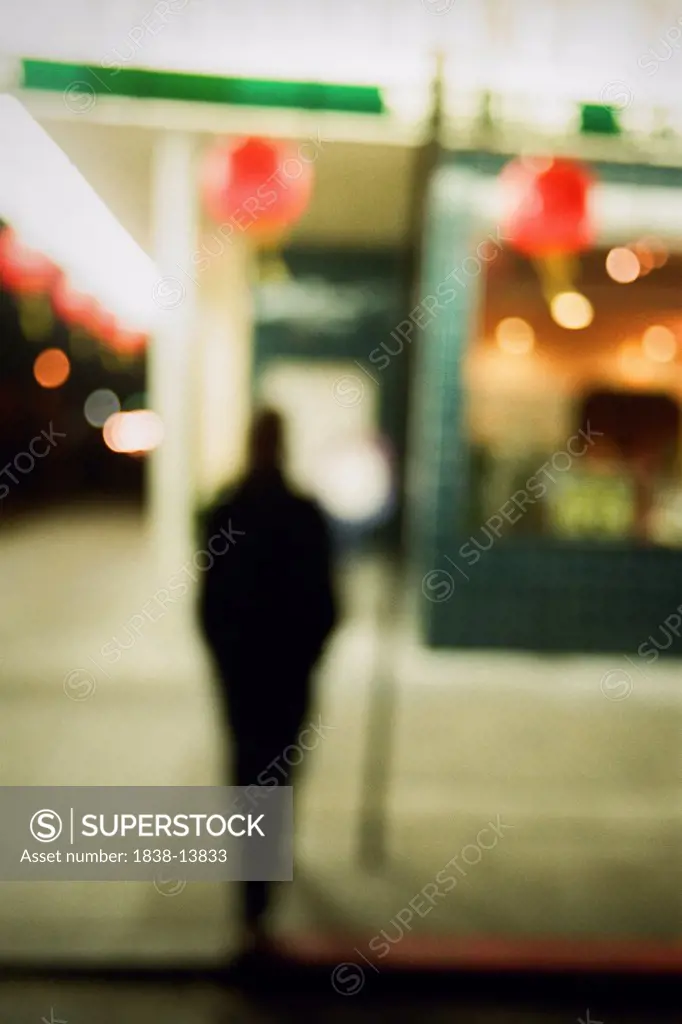 Blurred Woman Crossing Street at Night, Rear View