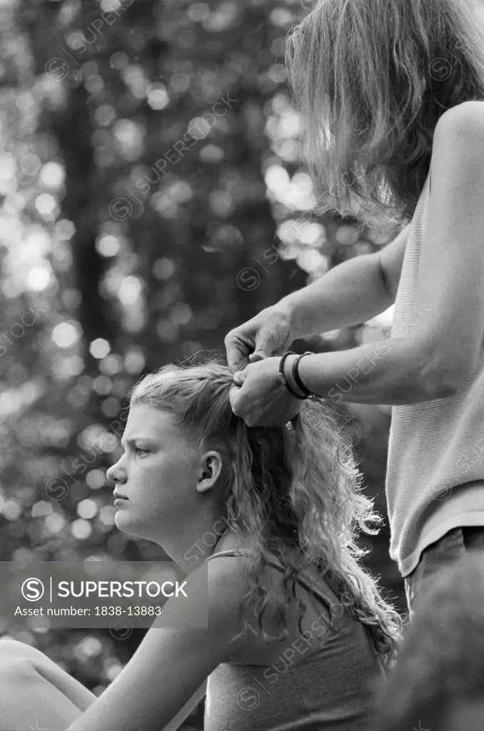 Mother Braiding Daughter's Hair