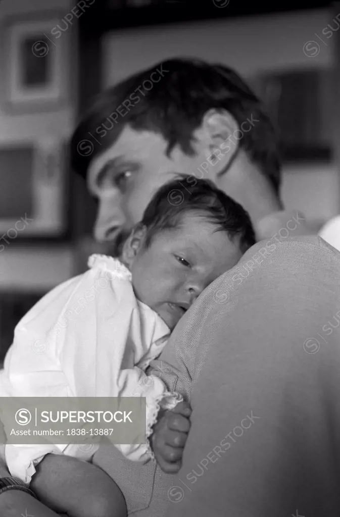 Father Holding Newborn Baby