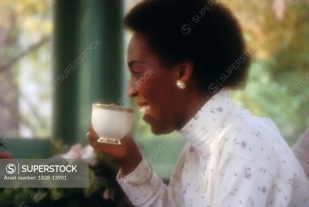 Woman Drinking Coffee on Porch