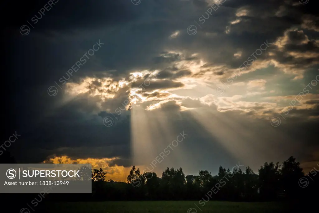 Rays of Sun Shining Through Dark Clouds