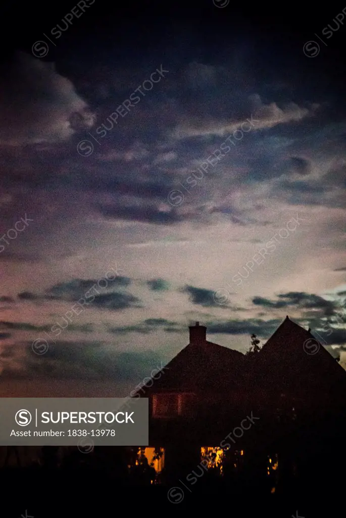 Dark House Under Moody Sky