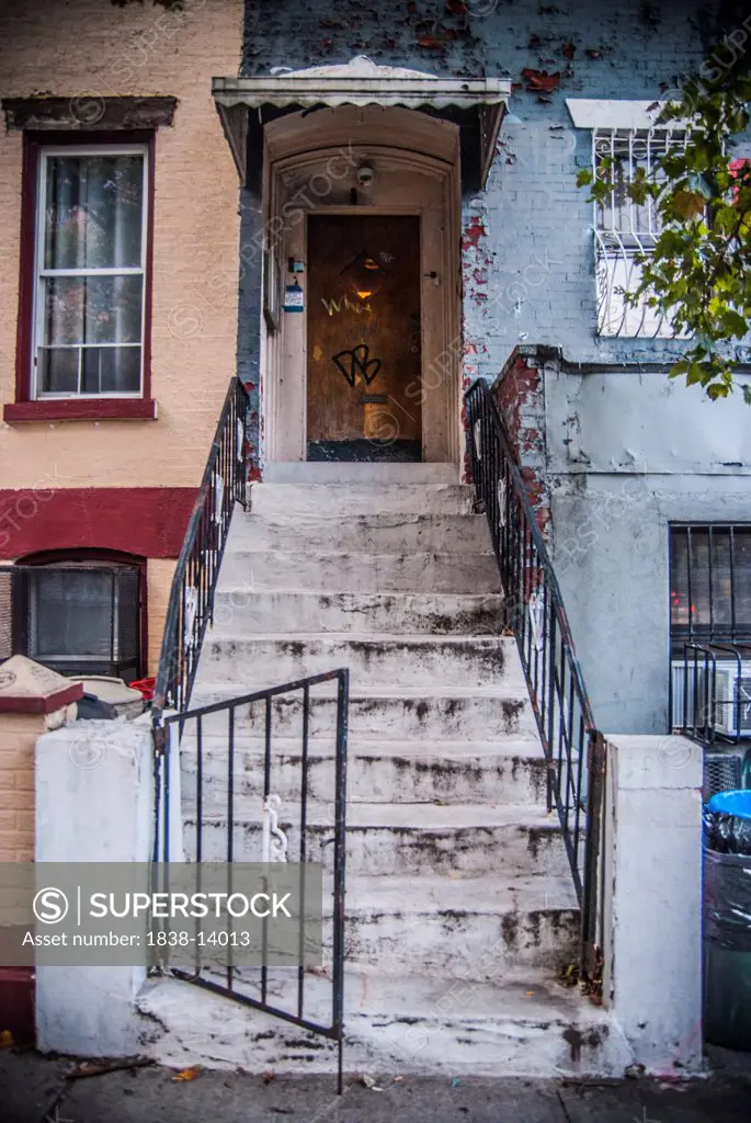 Gritty Urban Steps Leading to Front Door Covered in Graffiti, Williamsburg, Brooklyn NY