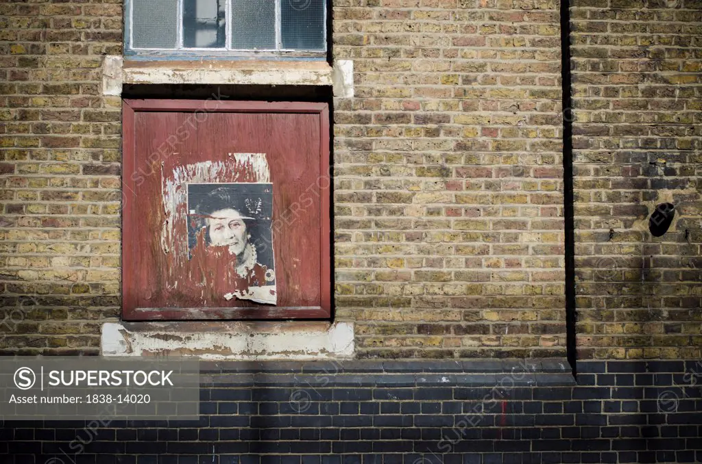Remains of a Poster of Margaret Thatcher on Brick Wall, London, England,  UK
