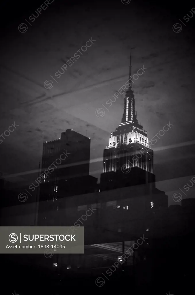 View of Empire State Building through Window at Night, New York City, USA