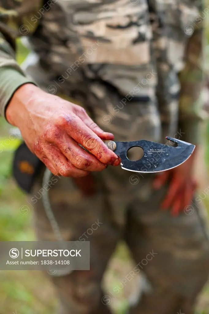 Bloody Hand With Hunting Knife