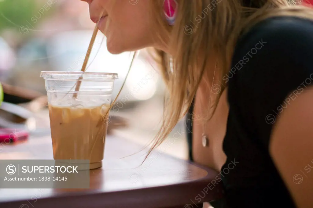 Woman Drinking Iced Coffee Drink Through Straw
