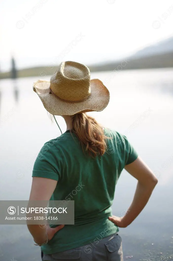 Young Woman in Hat Staring at Lake