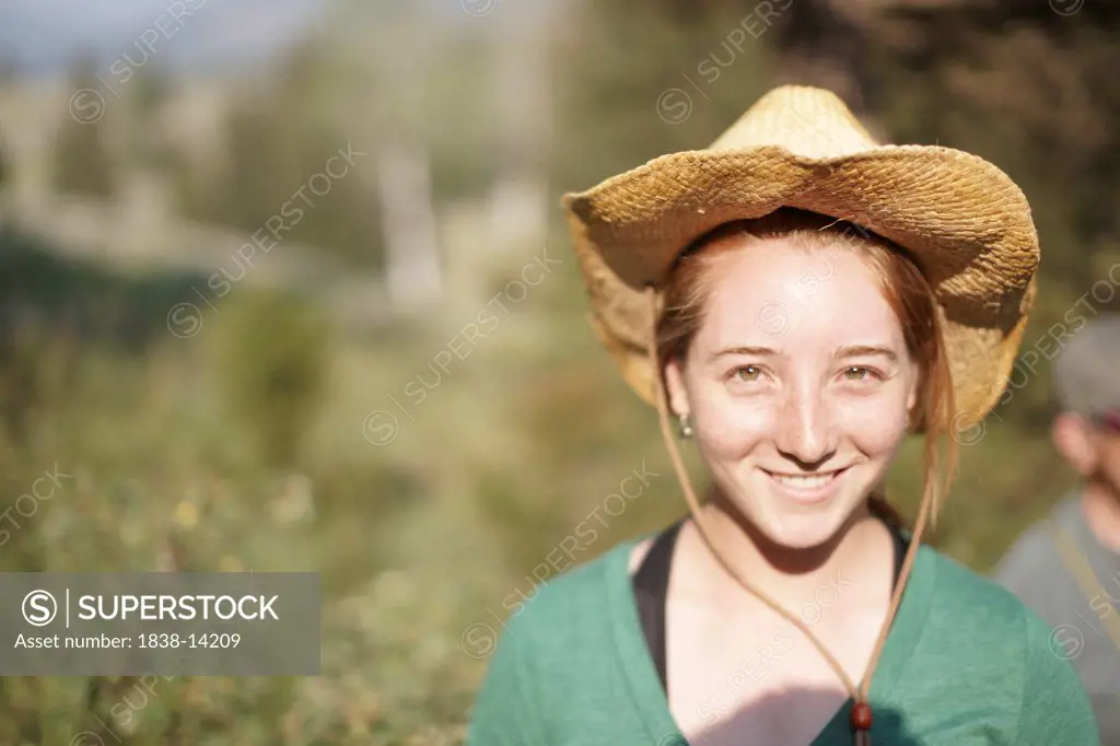 Smiling Young Woman Wearing Cowboy Hat, Portrait