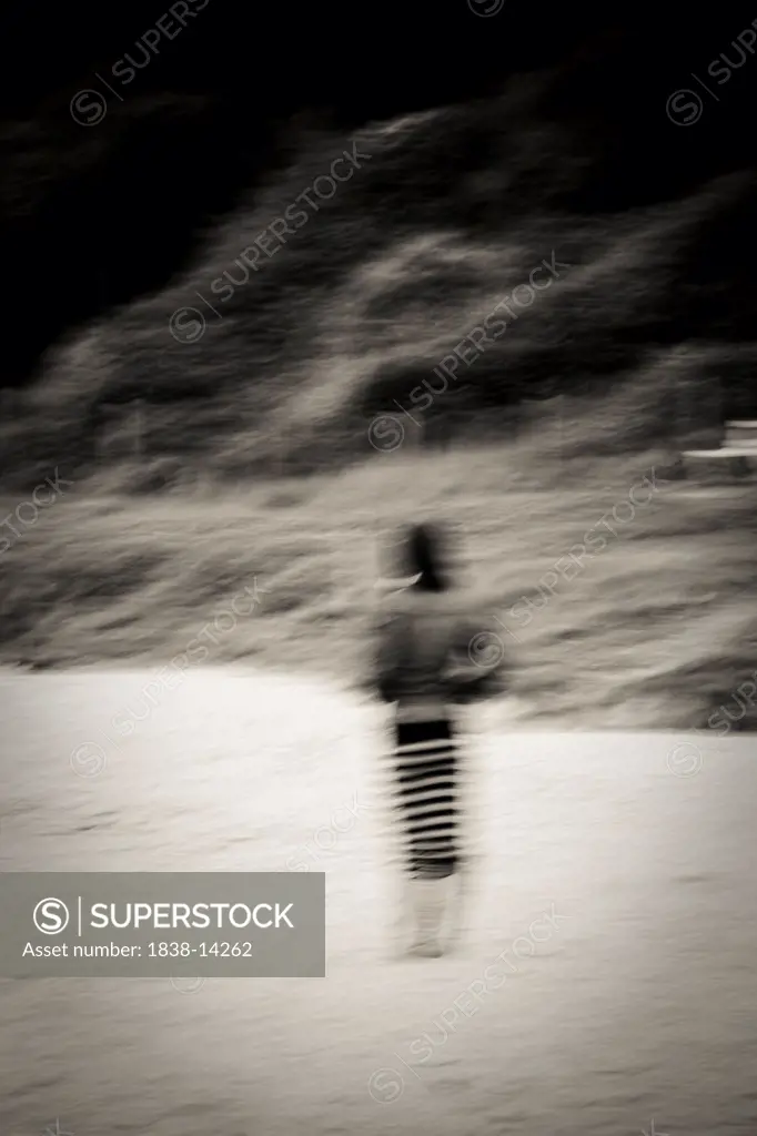 Blurred Woman Standing on Beach, Rear View