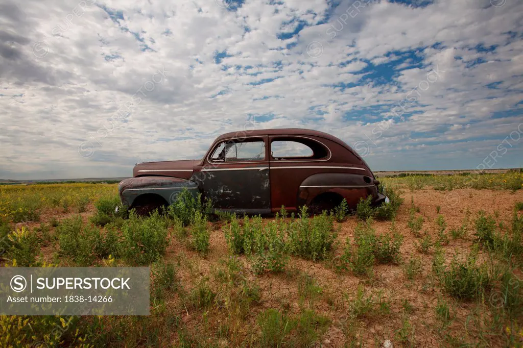 Old Abandonded Car in Field, Badlands National Park, South Dakota, USA