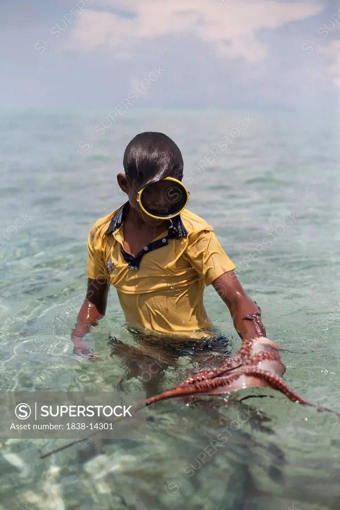 Boy Catching Octopus With Stick